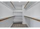 Bright walk-in closet with carpet and built in shelving units at 175 N Brookside St, Chandler, AZ 85225