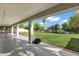 Covered patio with views of expansive backyard, mature trees, and beautiful landscaping at 175 N Brookside St, Chandler, AZ 85225