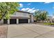 Charming home featuring a spacious driveway, a three-car garage, and manicured front yard at 175 N Brookside St, Chandler, AZ 85225