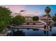 Wonderful lakefront property featuring a tiered backyard and mature trees at sunset at 175 N Brookside St, Chandler, AZ 85225
