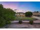 Two-story home with manicured lawn and backyard landscaping during twilight at 175 N Brookside St, Chandler, AZ 85225