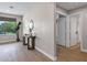 Hallway features wood floors, a decor table with mirror, and a view of the outside at 175 N Brookside St, Chandler, AZ 85225