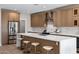 Modern kitchen with a large quartz island, stainless steel appliances, and light wood cabinets at 175 N Brookside St, Chandler, AZ 85225