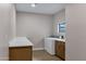 Spacious laundry room offers modern appliances, ample counter space, and plenty of storage at 175 N Brookside St, Chandler, AZ 85225