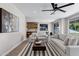 Beautiful living room with large windows, modern furniture, stylish ceiling fan and recessed lighting at 175 N Brookside St, Chandler, AZ 85225