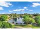 View of the pond with a mature palm tree, manicured landscaping and mature trees at 175 N Brookside St, Chandler, AZ 85225