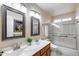Bathroom with double vanity, framed mirrors, and shower with glass door at 17500 N 85Th Dr, Peoria, AZ 85382