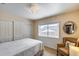 Bedroom with sliding closet doors, large window, and comfortable chair at 17500 N 85Th Dr, Peoria, AZ 85382