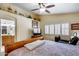 Bedroom with ceiling fan, exterior window, warm paint tones, and a cozy bed, perfect for relaxation at 17500 N 85Th Dr, Peoria, AZ 85382