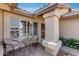Covered entryway with decorative tile, seating, and a view of the security door at 17500 N 85Th Dr, Peoria, AZ 85382