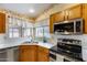 Updated kitchen with stainless steel appliances and a view of the yard at 17500 N 85Th Dr, Peoria, AZ 85382