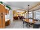 Open-concept kitchen with tile floors, wood cabinets, views to the living room, and a cozy chandelier at 17500 N 85Th Dr, Peoria, AZ 85382