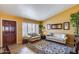 Bright living room with neutral furniture, plantation shutters, and decorative rug at 17500 N 85Th Dr, Peoria, AZ 85382