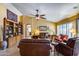 Comfortable living room with fireplace, ceiling fan and bookshelves at 17500 N 85Th Dr, Peoria, AZ 85382