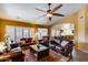 Large living room with ceiling fan, tile floors and multiple seating areas at 17500 N 85Th Dr, Peoria, AZ 85382
