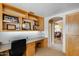 Home office features custom built-in shelves and a glimpse into the living room at 17500 N 85Th Dr, Peoria, AZ 85382