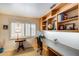 Home office featuring built-in shelves, a long desk, natural light, and neutral carpet at 17500 N 85Th Dr, Peoria, AZ 85382