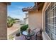 Outdoor patio with charming table and chair set plus a view of the street at 17500 N 85Th Dr, Peoria, AZ 85382