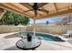 Covered backyard patio with a view of the inviting pool at 17500 N 85Th Dr, Peoria, AZ 85382