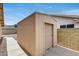 Backyard shed with a rolling door, adjacent to the home, offering convenient storage at 17500 N 85Th Dr, Peoria, AZ 85382