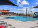 Relaxing community pool with shade structures and a splash pad for play at 17576 W Adams St, Goodyear, AZ 85338