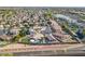 Aerial of a well-planned neighborhood with lush green lawns, sparkling pools, and shopping nearby at 20017 N 65Th Dr, Glendale, AZ 85308