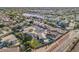 Aerial view of a well-planned community with shopping nearby, mature trees and swimming pools at 20017 N 65Th Dr, Glendale, AZ 85308