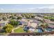 Backyard aerial view showcasing pool, patio, green grass, and neighborhood views at 20017 N 65Th Dr, Glendale, AZ 85308