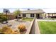 Spacious backyard featuring a basketball hoop, grassy area, and mature landscaping for outdoor enjoyment at 20017 N 65Th Dr, Glendale, AZ 85308