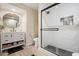 Contemporary bathroom features a shower, a round mirror and vanity, and wood-look floors at 20017 N 65Th Dr, Glendale, AZ 85308