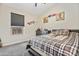Neutral-toned bedroom showcasing a window with blinds, ceiling fan, baseball themed art and dark wood furnishings at 20017 N 65Th Dr, Glendale, AZ 85308