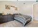 A cozy, carpeted bedroom with baseball decor, a ceiling fan, and a view to the outside at 20017 N 65Th Dr, Glendale, AZ 85308