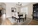 Bright dining room area featuring a ceiling fan, shutters, and a table with six chairs set on a decorative area rug at 20017 N 65Th Dr, Glendale, AZ 85308