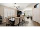 Bright dining room featuring a ceiling fan, shutters on the windows, and a dining table with upholstered chairs at 20017 N 65Th Dr, Glendale, AZ 85308