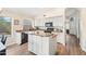Bright kitchen featuring white cabinets, black appliances, and wood-look tile flooring at 20017 N 65Th Dr, Glendale, AZ 85308
