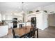 Bright kitchen featuring black appliances, white cabinets, and modern lighting fixtures at 20017 N 65Th Dr, Glendale, AZ 85308