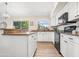 Bright kitchen featuring white cabinets, black appliances, and granite countertops at 20017 N 65Th Dr, Glendale, AZ 85308