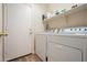 Functional laundry room featuring a washer, dryer, a shelf, and access to the outside at 20017 N 65Th Dr, Glendale, AZ 85308