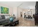 Open-concept living room with neutral decor, a gray sofa, a dark coffee table, and a view into the dining area at 20017 N 65Th Dr, Glendale, AZ 85308