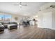 Bright, open living room with vaulted ceilings, and wood tile flooring open to dining area at 20017 N 65Th Dr, Glendale, AZ 85308