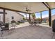 Covered patio with comfortable seating, ceiling fan, and a view of the pool and backyard at 20017 N 65Th Dr, Glendale, AZ 85308