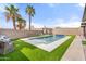 Beautiful pool with custom water feature, surrounded by well-maintained turf and lush landscaping at 20017 N 65Th Dr, Glendale, AZ 85308