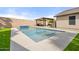 Sparkling pool with a tiled water feature and a covered patio with outdoor seating; perfect for entertaining at 20017 N 65Th Dr, Glendale, AZ 85308