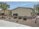 View of a desert landscape home with gravel yard and low maintenance bushes under a partly cloudy blue sky at 2206 S Ellsworth Rd # 129B, Mesa, AZ 85201