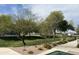 Community green space with trees and flowering plants providing a peaceful setting for residents to enjoy at 2206 S Ellsworth Rd # 129B, Mesa, AZ 85201