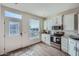 Bright kitchen with white cabinets, stainless steel appliances, and wood-look tile flooring at 2206 S Ellsworth Rd # 129B, Mesa, AZ 85201