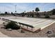 Community shuffleboard courts with benches surrounded by landscaping and beautiful Arizona desert views at 2206 S Ellsworth Rd # 129B, Mesa, AZ 85201
