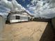 A partially fenced backyard of an in-progress home with a blue sky and clouds at 2385 E Spur Dr, San Tan Valley, AZ 85140