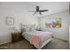 Cozy bedroom with a ceiling fan, and a large window providing plenty of natural light at 2539 E Geneva Dr, Tempe, AZ 85282