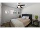 Inviting bedroom offers carpeted floors, a ceiling fan, and a window for natural light at 2539 E Geneva Dr, Tempe, AZ 85282